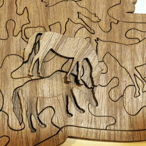Laser cut walnut plywood horse puzzle with intricate horse-shaped pieces, reusable storage bag, care instructions, and solution guide for horse lovers.