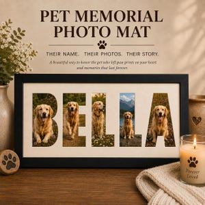 May include: A black rectangular photo frame containing a white mat with five cutouts forming the name BELLA. Each letter displays a photograph of a golden retriever. Text above reads PET MEMORIAL PHOTO MAT, THEIR NAME. THEIR PHOTOS. THEIR STORY.