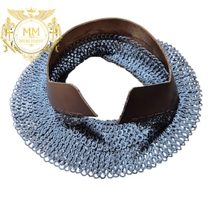 May include: A chainmail coif with a brown leather neck guard. The chainmail is made of small, interlocking metal rings. The leather neck guard is a dark brown color and is stitched to the chainmail. The coif is designed to protect the neck and head.