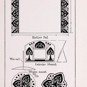 May include: A black and white illustration of a desk set with a blotter pad, calendar mount, pen wiper, and a design for a file. The design features a repeating pattern of stylized leaves and flowers.