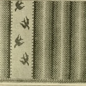 May include: A close-up of a woven fabric with a pattern of diagonal stripes in shades of gray. The fabric has a border with a repeating pattern of stylized birds.