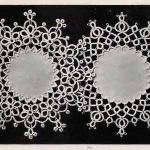 May include: Two white crocheted doilies with a circular design. The doilies have a delicate floral pattern and are set against a black background.