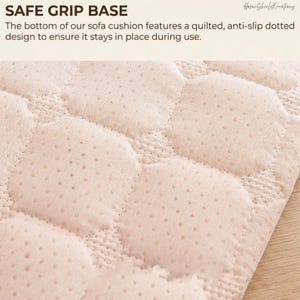 May include: Close-up of a beige sofa cushion base with a quilted, dotted design. The text "SAFE GRIP BASE" is at the top, with additional text describing the anti-slip feature. The cushion is designed to stay in place during use.