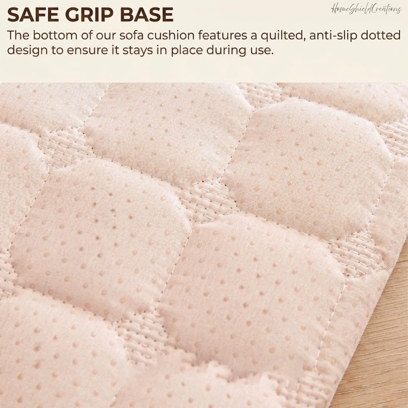 May include: Close-up of a beige sofa cushion base with a quilted, dotted design. The text "SAFE GRIP BASE" is at the top, with additional text describing the anti-slip feature. The cushion is designed to stay in place during use.