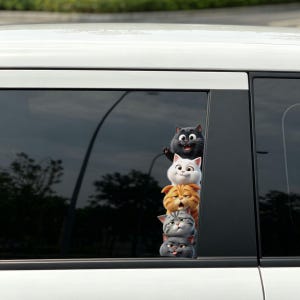 May include: A vertical car window decal featuring a stack of five cartoon cats. The top cat is black, followed by a white cat, an orange tabby, a gray tabby, and a dark gray cat at the bottom, each displaying a unique facial expression.
