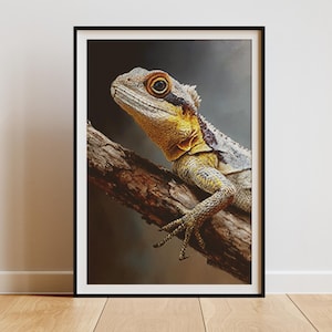 May include: Framed print featuring a detailed image of a lizard perched on a branch. The lizard has a yellow and gray body with a spiky crest and is set against a dark background. The artwork is displayed in a black frame.