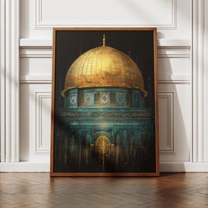 May include: A framed art print depicting the Dome of the Rock. The image shows the golden dome set against a dark backdrop, with turquoise and gold architectural details. The print is displayed on a wooden floor.