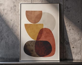 Puede incluir: Lámina de arte abstracto con formas geométricas superpuestas en tonos cálidos de tierra. El diseño incluye semicírculos, óvalos y formas redondeadas en tonos marrón, amarillo y rojo, sobre un fondo crema. La obra está enmarcada en un marco de metal plateado.