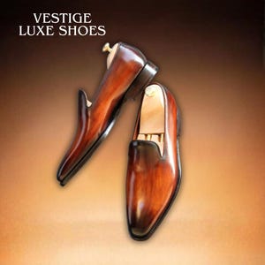 Patina Wholecut Loafers For Men on brown surface