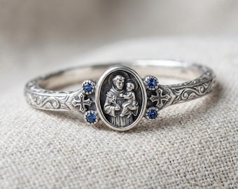 Anillo de San Antonio para Niño, de plata, con cruz de piedra azul y medallón religioso.