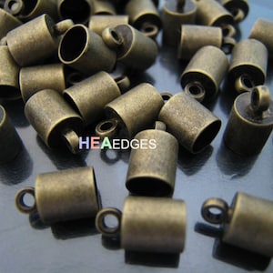 Fynd - 10 st. ändhylsor i antikmässing med ögla för runda lädertrådar 10 mm x 6 mm (innerdiameter 5 mm)