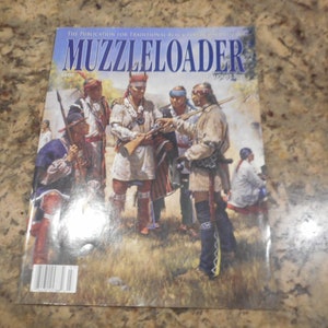 May include: A magazine cover featuring a colorful illustration of Native Americans in traditional clothing, holding rifles and other weapons. The magazine is titled "Muzzleloader" and the issue date is August 2003.