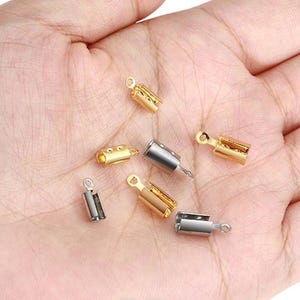 May include: A selection of small metal cord end crimps in gold and silver. These crimps have a loop for attaching to a cord and are designed to secure the ends of jewellery cords or other craft projects.
