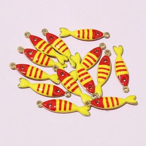 May include: A selection of yellow and red fish-shaped charms with gold loops, perfect for jewellery making. The charms feature red heads and tails, yellow bodies, and red stripes. Ideal for crafting projects.