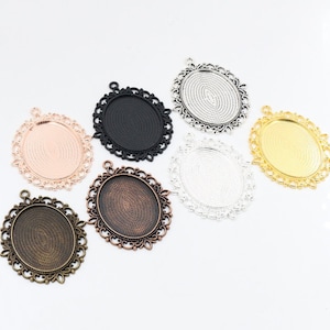 May include: Seven oval-shaped metal pendant trays with ornate edges. The trays are in various colors, including gold, silver, black, copper, and rose gold.