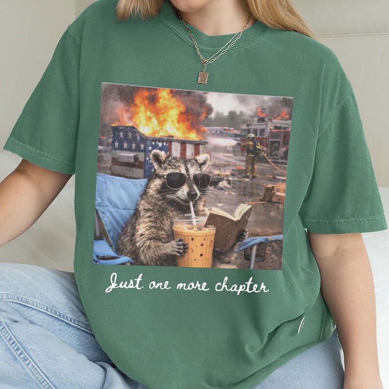 May include: A white ceramic mug with a black handle and the text "But First, Coffee" in a bold, black font. The mug is set against a blurred background, suggesting a cozy setting.