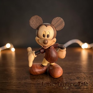 May include: A set of three ceramic mugs with a speckled, matte finish. The mugs are in shades of cream, light gray, and dark gray. Each mug has a simple, minimalist design and a rounded handle.