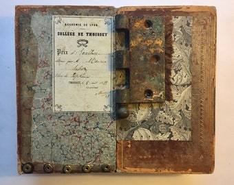 Mixed media assemblage, antique French college book, rusted hinge