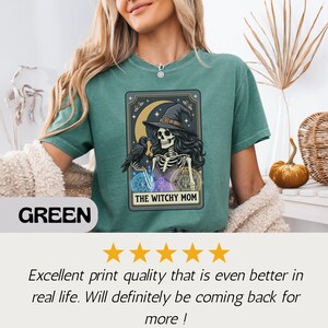 Green t-shirt with "The Witchy Mom" skeleton and raven graphic.