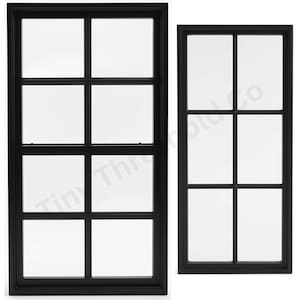 May include: Two black framed windows with multiple panes of clear glass. The windows are rectangular and have a grid-like pattern created by the black frames. The windows are set against a white background.