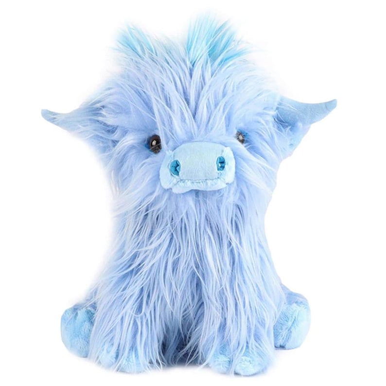 May include: A light blue plush Highland cow stuffed animal with long, shaggy fur. The toy has small, dark eyes, a light blue snout, and small ears. The cow is sitting upright, with its legs tucked beneath it.