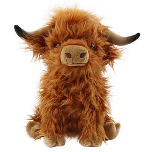 May include: A plush Highland cow toy with shaggy, reddish-brown fur. The stuffed animal has a light brown snout, small brown eyes, and curved horns with black tips. The toy is sitting upright with its legs extended.