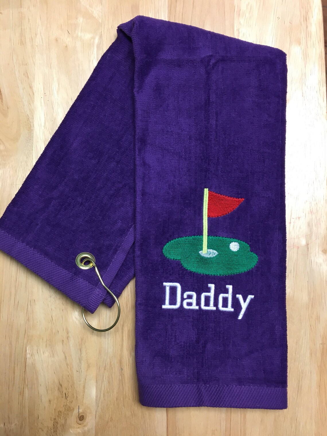 Personalized golf towel with custom embroidery included in the Etsy