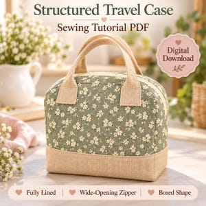 May include: A structured travel case sewing tutorial PDF featuring a sage green fabric with a white floral pattern and a tan base. The bag has two top handles, a wide-opening zipper, a boxed shape, and is fully lined. Text includes Structured Travel Case, Sewing Tutorial PDF, and Digital Download.