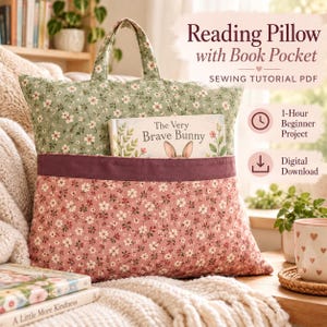 May include: A reading pillow with a book pocket featuring a green and pink floral pattern, a top handle, and a dark pink trim. The pillow holds a book titled The Very Brave Bunny. Text includes Reading Pillow with Book Pocket SEWING TUTORIAL PDF.
