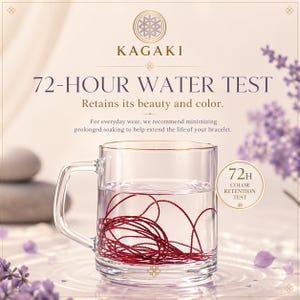 May include: A clear glass mug filled with water, containing a tangled red string. The image includes text that reads "KAGAKI 72-HOUR WATER TEST" and "Retains its beauty and color." A smaller circle reads "72H COLOR RETENTION TEST."