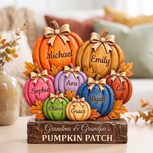 May include: A decorative wooden pumpkin patch display featuring seven carved pumpkins in orange, yellow, pink, purple, blue, green, and tan. Each pumpkin is topped with a bow and engraved with names: Michael, Emily, Sophia, Ava, Wyatt, Leo, Oliver, and Grace.