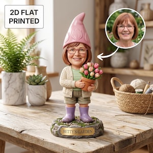 May include: A custom garden gnome figurine of a woman with glasses, holding tulips. The gnome wears a pink hat, cream cardigan, and purple wellington boots. The base reads "Betty's Garden". The image also includes a 2D flat printed sign.