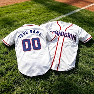 May include: Two white baseball jerseys with red piping and blue lettering. One jersey displays the text "DOMINICANA" on the front, while the other shows "YOUR NAME" and the number "00" in blue with red outlines on the back. Both feature button-down fronts.