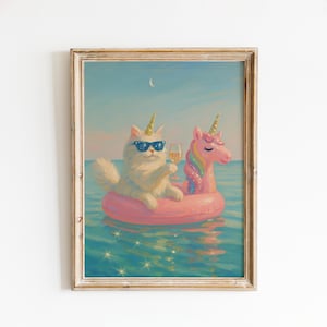 May include: A framed print depicts a white cat wearing sunglasses and a unicorn horn, floating on a pink inflatable ring in the ocean. The cat holds a glass of champagne. A pink unicorn floatie is next to the cat. The artwork is set against a blue sky and water.