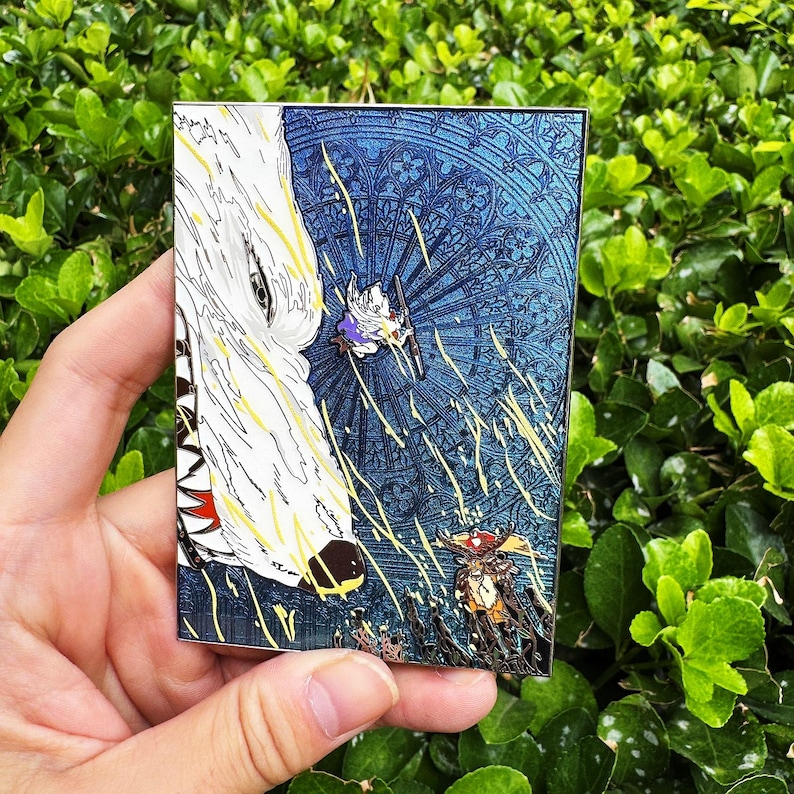 May include: A rectangular enamel pin featuring a fantasy scene. A large white wolf head is on the left, with a blue background depicting a stained-glass window design. Two figures are in the center, with yellow and orange accents.