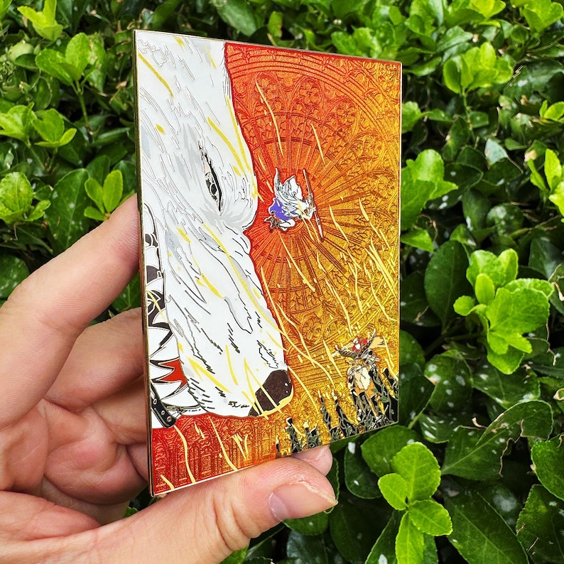 May include: A rectangular enamel pin featuring a detailed illustration. The design includes a white wolf's head on the left and a vibrant, detailed scene on the right with figures and a sunburst background. The pin has a gold border.