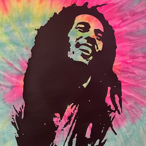 May include: A black silhouette of Bob Marley with dreadlocks, singing with his eyes closed and hands raised. The background is a tie-dye pattern in shades of pink, yellow, and blue.