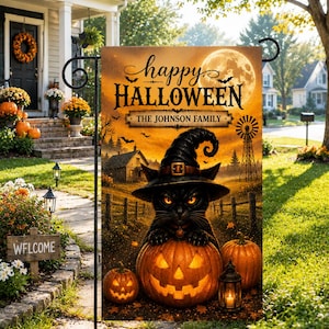 May include: A rectangular garden flag featuring a black cat wearing a witch hat perched on a glowing jack-o'-lantern. The scene includes a full moon, a windmill, and a house, with the text "happy HALLOWEEN" and "THE JOHNSON FAMILY" printed.