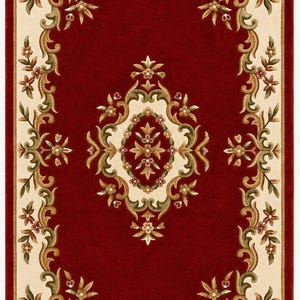 May include: A rectangular area rug featuring a deep red center field with a central cream-colored floral medallion. The border consists of a cream-colored frame decorated with scrolling green and brown vine motifs and small floral accents.