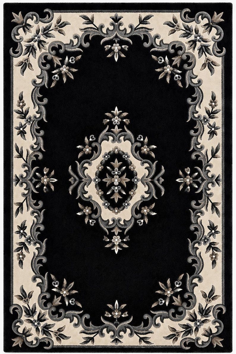 May include: A rectangular area rug featuring a deep black center and a cream-colored border. The design includes intricate floral and scrollwork patterns in shades of charcoal gray, slate, and soft beige, centered around a symmetrical medallion.