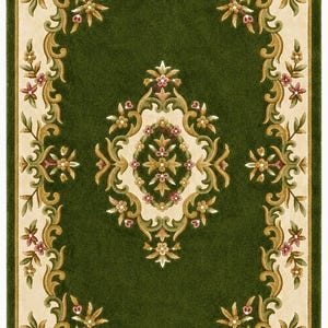 May include: A rectangular area rug featuring a deep forest green center field with a central cream-colored medallion. The border is cream with scrolling green and gold acanthus leaf motifs and small pink floral accents throughout the design.