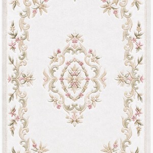 May include: A rectangular area rug featuring a cream-colored background with a central medallion and a decorative border. The design consists of intricate scrolling foliage, vines, and small floral motifs in shades of sage green and soft pink.