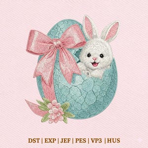 May include: An embroidered Easter design featuring a white bunny emerging from a cracked blue egg. A large pink bow and floral accents adorn the egg. The design is set against a pink background.