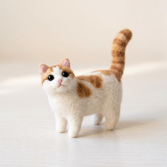 Wool Felt Cat: Meticulously hand-shaped from dense wool, featuring a lively raised tail for bedside comfort.