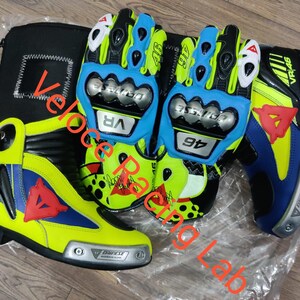 May include: A set of motorcycle gear, including a pair of blue and yellow gloves, a matching boot, and a black carrying case. The gloves and boot feature the number "46" and the "VR" logo. The boot has a red triangle design.
