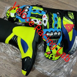 May include: Motorcycle racing gear set including a neon yellow and black boot, and blue, black, and yellow gloves. The gloves and boot have a sporty design with the text "VR46" and "Dainese".