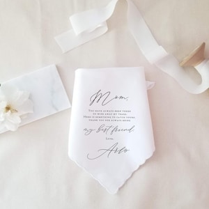 mother of the bride handkerchief laying beside a spool of ribbon