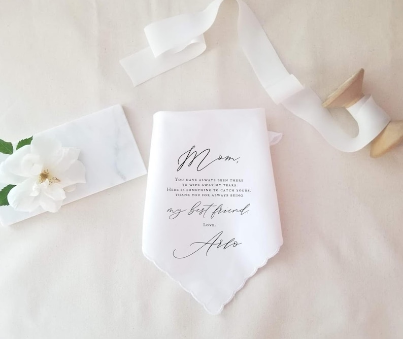 mother of the bride handkerchief laying beside a spool of ribbon