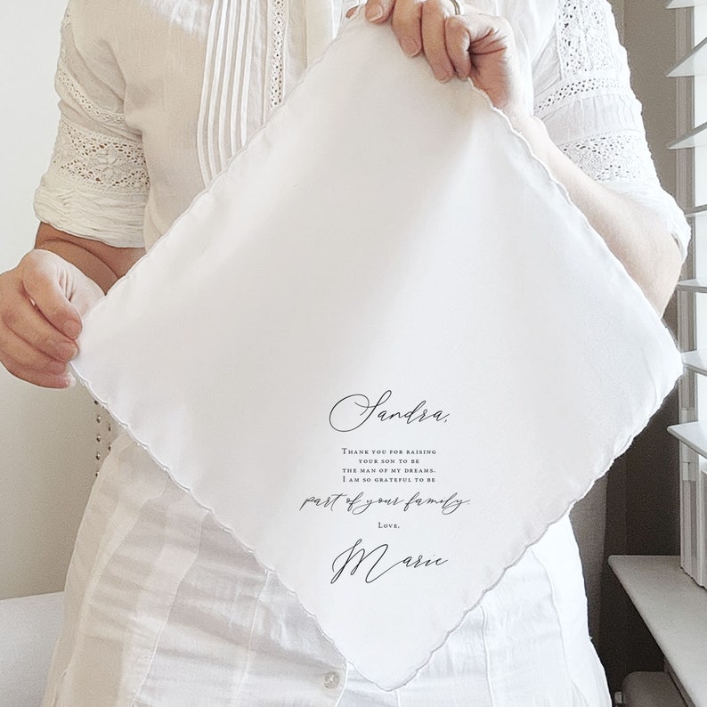 bride holding handkerchief for mother of the groom