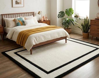 Alfombra de lana tejida a mano: Alfombra moderna color crema con borde negro para dormitorio.